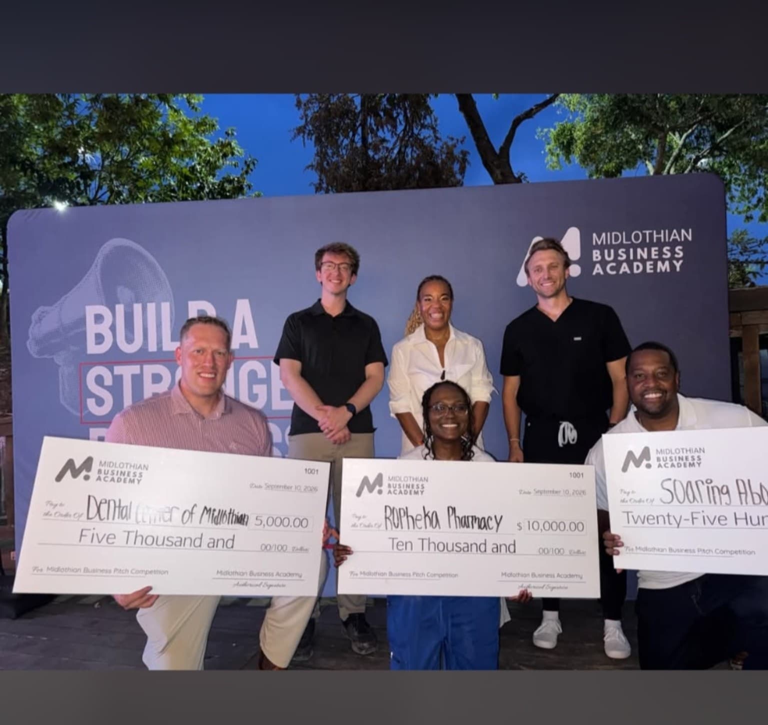 Raheal Boadi-Yeboah of Rophéka Pharmacy holding the $10,000 first-place award check from the 2026 Midlothian Business Pitch Competition