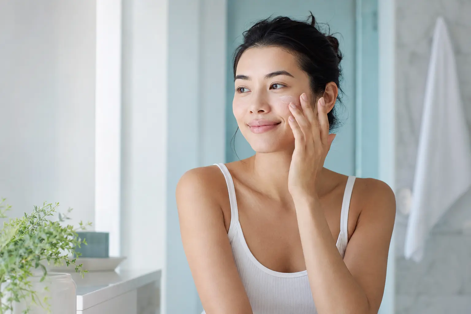 An adult woman in a bright, modern skin-care setting